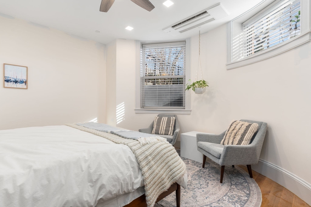 1762 Beacon Street, Unit 1 Brookline, MA 02445 - Photo 8 of 17 a bedroom with a bed and a chair