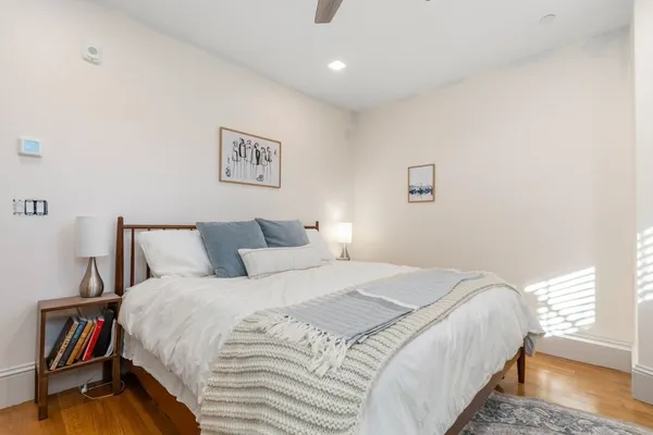 a bedroom with bed and a night stand