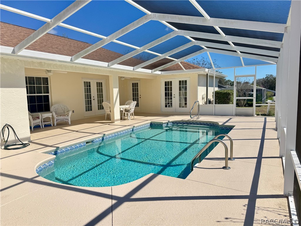 4588 East Van Ness Road Inverness, FL 34453 - Photo 28 of 34 a view of a patio with a table and chairs under an umbrella