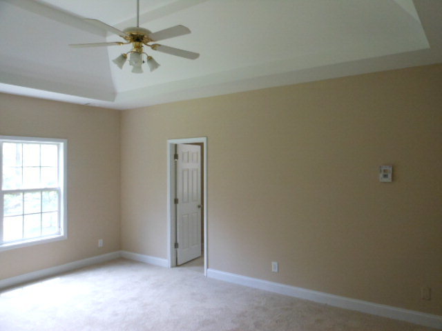 173 Gordon Road Gray, GA 31032 - Photo 11 of 18 an empty room with a window and a fan