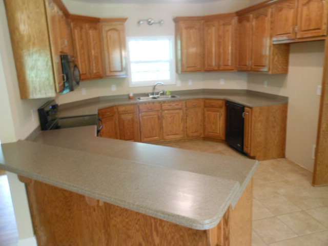 173 Gordon Road Gray, GA 31032 - Photo 17 of 18 a kitchen with a sink and a refrigerator