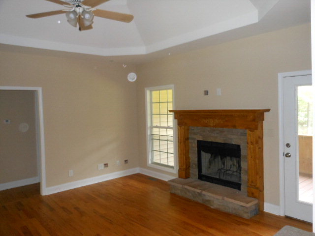 173 Gordon Road Gray, GA 31032 - Photo 3 of 18 a view of an empty room with a fireplace and a window