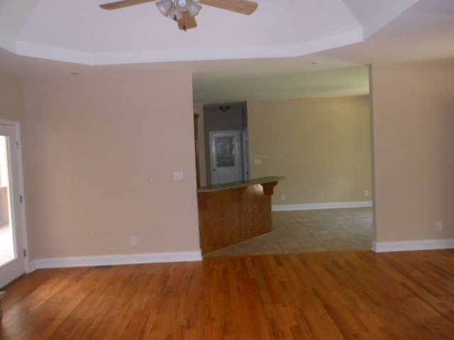 173 Gordon Road Gray, GA 31032 - Photo 7 of 18 an empty room with wooden floor and windows