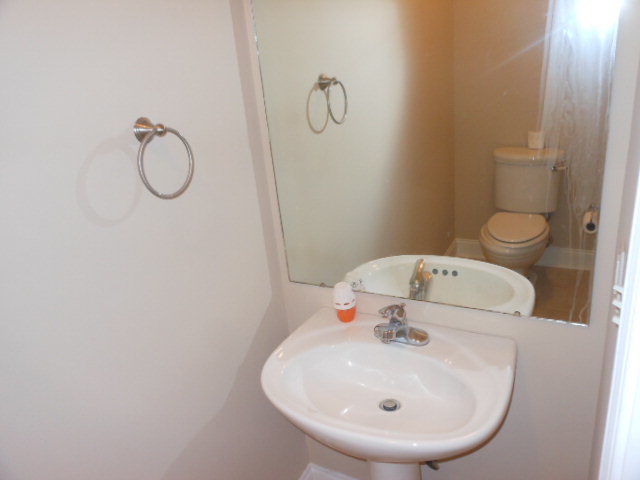 173 Gordon Road Gray, GA 31032 - Photo 10 of 18 a bathroom with a sink a toilet and a mirror