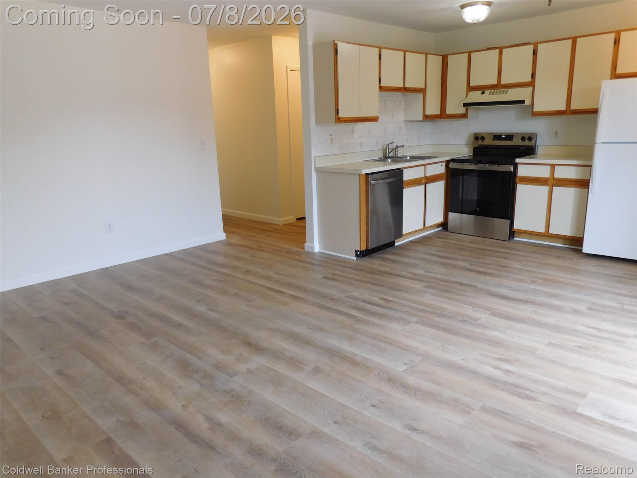 284 East 13 Mile Road Madison Heights, MI 48071 - Photo 9 of 21 Open-concept living area with wood-finish flooring extending into the kitchen