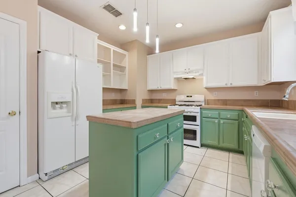 a kitchen with a sink window and cabinets