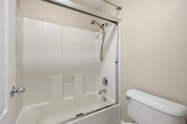 a bathroom with a shower and a toilet