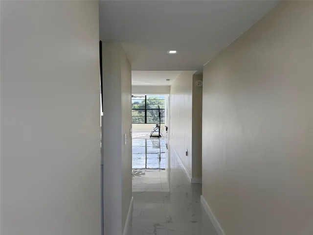 a view of hallway with wooden floor