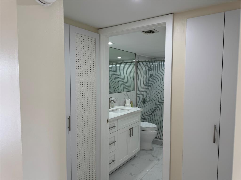 1520 Whitehall Drive, Unit 306 Davie, FL 33324 - Photo 12 of 42 a bathroom with a double vanity sink toilet and shower