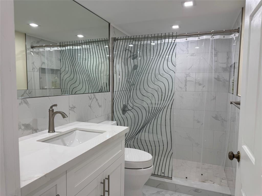 1520 Whitehall Drive, Unit 306 Davie, FL 33324 - Photo 13 of 42 a bathroom with a sink a toilet and shower