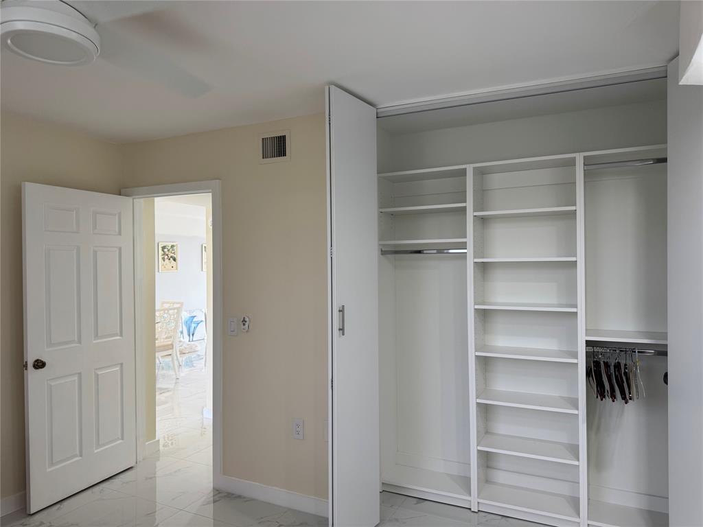 1520 Whitehall Drive, Unit 306 Davie, FL 33324 - Photo 16 of 42 a view of walk in closet with empty racks