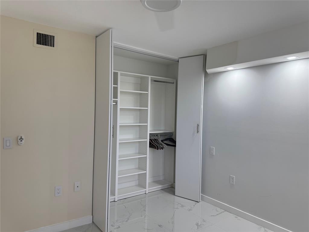 1520 Whitehall Drive, Unit 306 Davie, FL 33324 - Photo 17 of 42 a view of walk in closet with empty racks