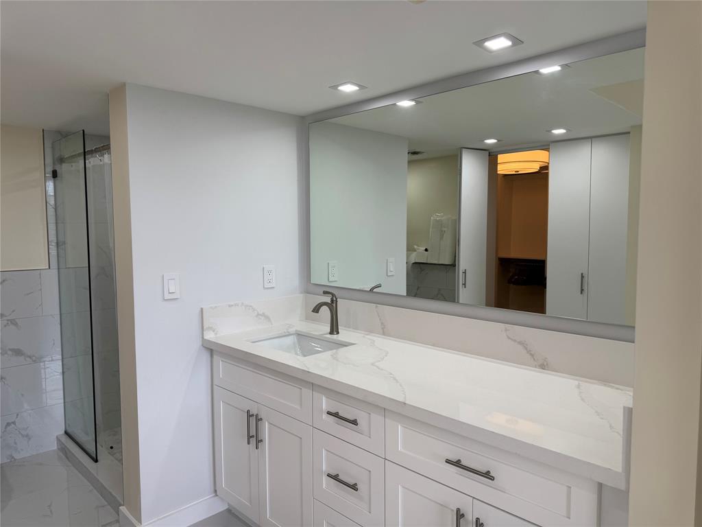 1520 Whitehall Drive, Unit 306 Davie, FL 33324 - Photo 21 of 42 a bathroom with a sink and a mirror