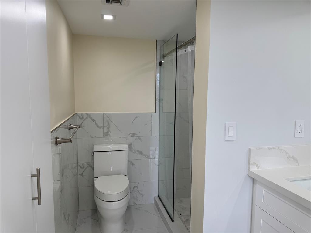 1520 Whitehall Drive, Unit 306 Davie, FL 33324 - Photo 23 of 42 a bathroom with a toilet and a sink