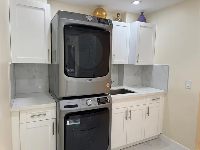 a kitchen with a white cabinets and white sink