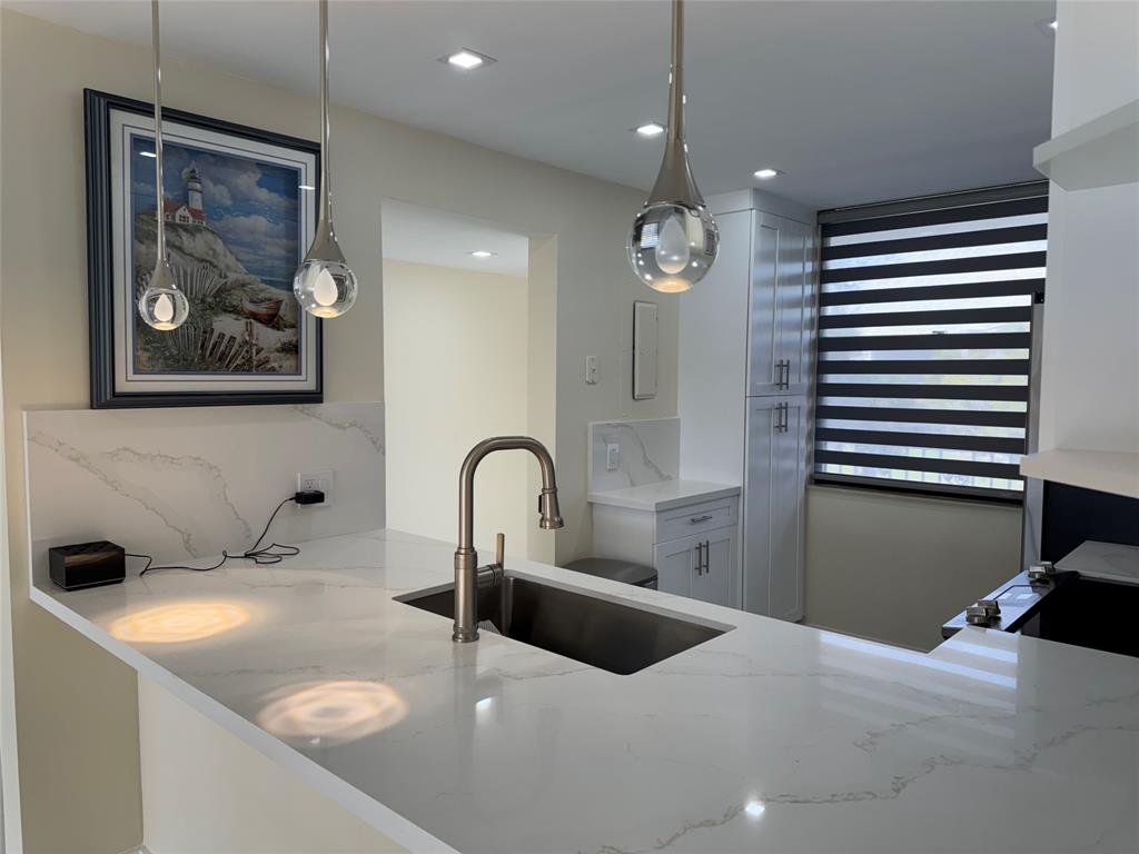 1520 Whitehall Drive, Unit 306 Davie, FL 33324 - Photo 35 of 42 a bathroom with a sink and a mirror