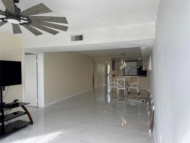 a dining room with furniture and a flat screen tv