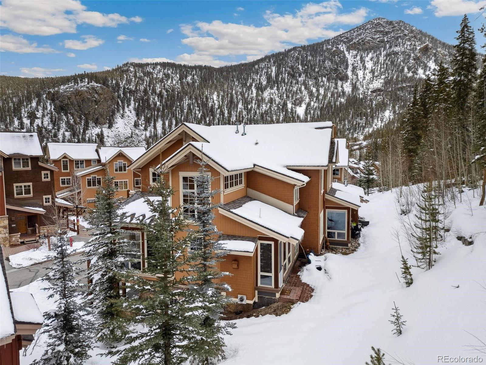 a view of a house with a yard covered in snow