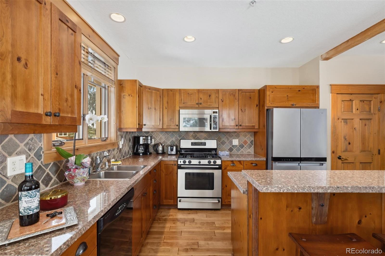 129 Tip Top Trail, Unit 6543 Dillon, CO 80435 - Photo 11 of 40 a kitchen with stainless steel appliances granite countertop a stove a sink and a refrigerator