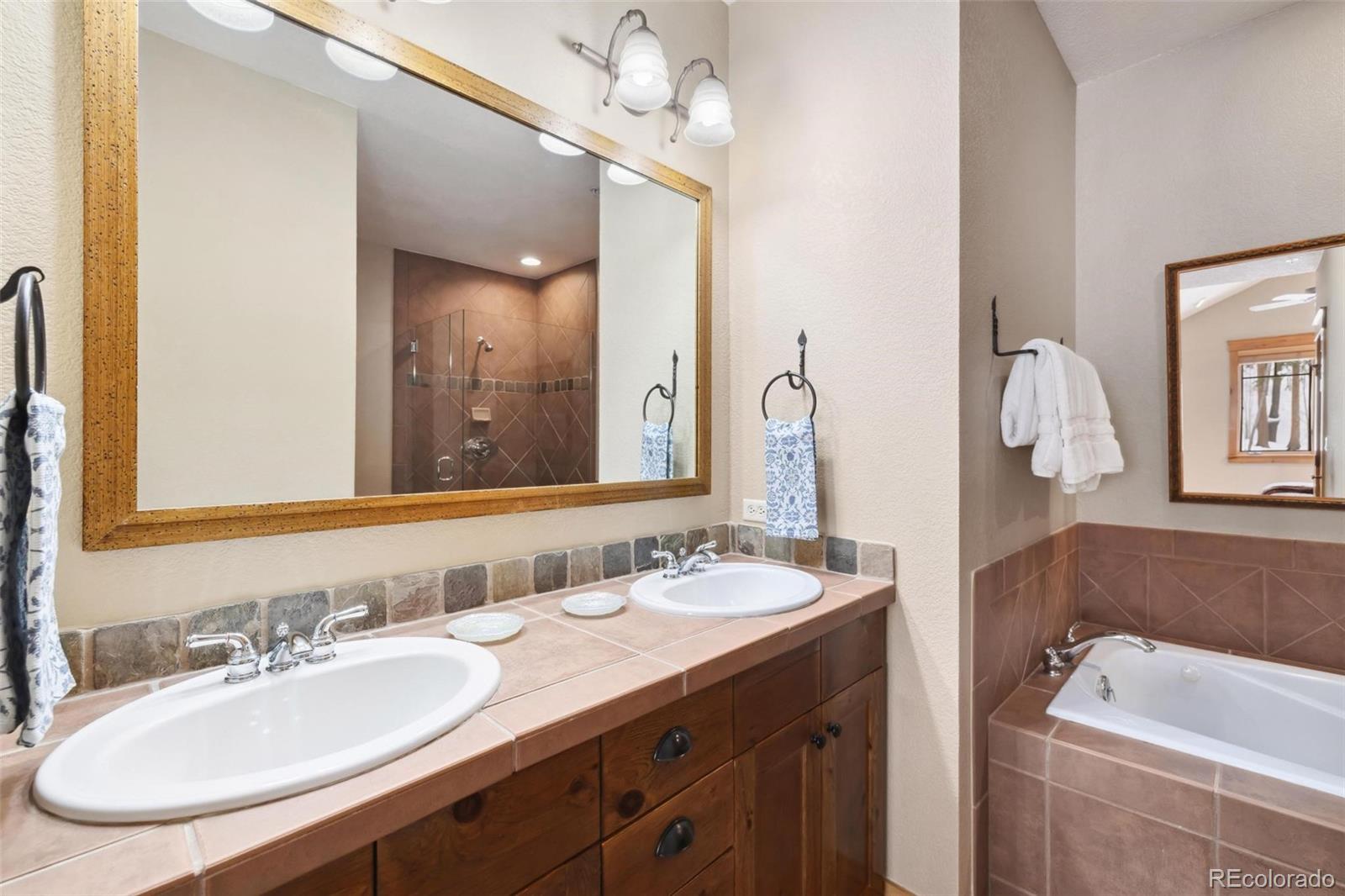 129 Tip Top Trail, Unit 6543 Dillon, CO 80435 - Photo 17 of 40 a bathroom with a sink double vanity granite and a mirror