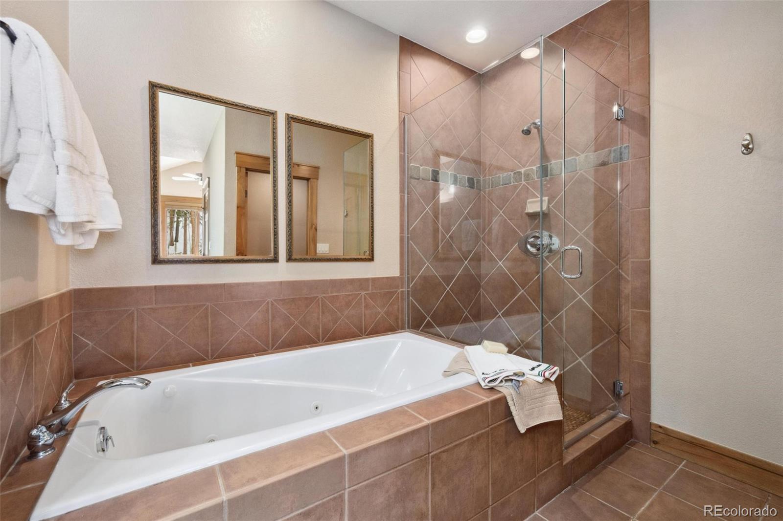 129 Tip Top Trail, Unit 6543 Dillon, CO 80435 - Photo 18 of 40 a bathroom with a tub and a shower