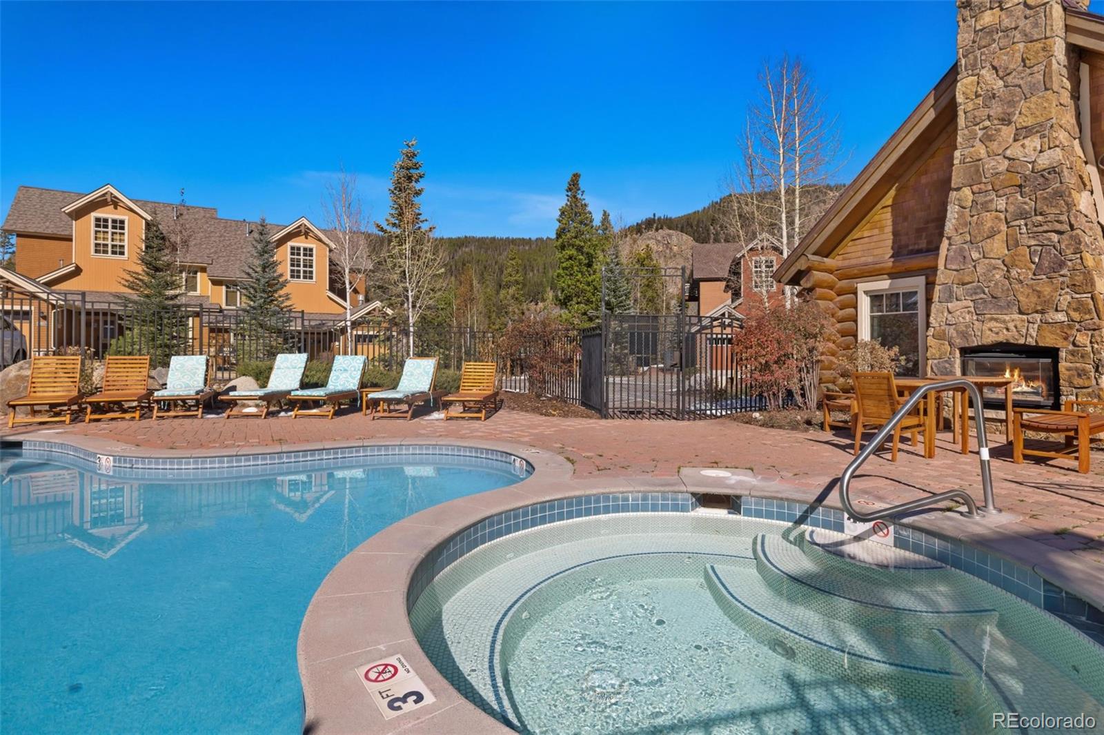 129 Tip Top Trail, Unit 6543 Dillon, CO 80435 - Photo 36 of 40 a view of a swimming pool with a house in the background