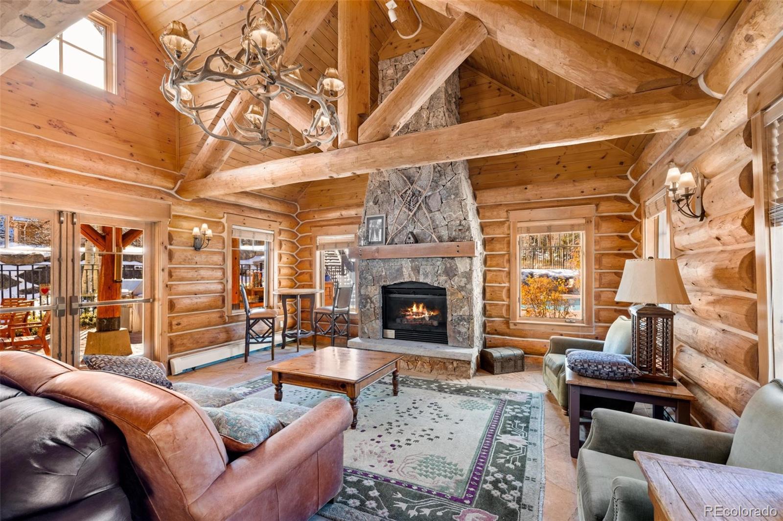 129 Tip Top Trail, Unit 6543 Dillon, CO 80435 - Photo 39 of 40 a living room with furniture a fireplace and a black umbrella