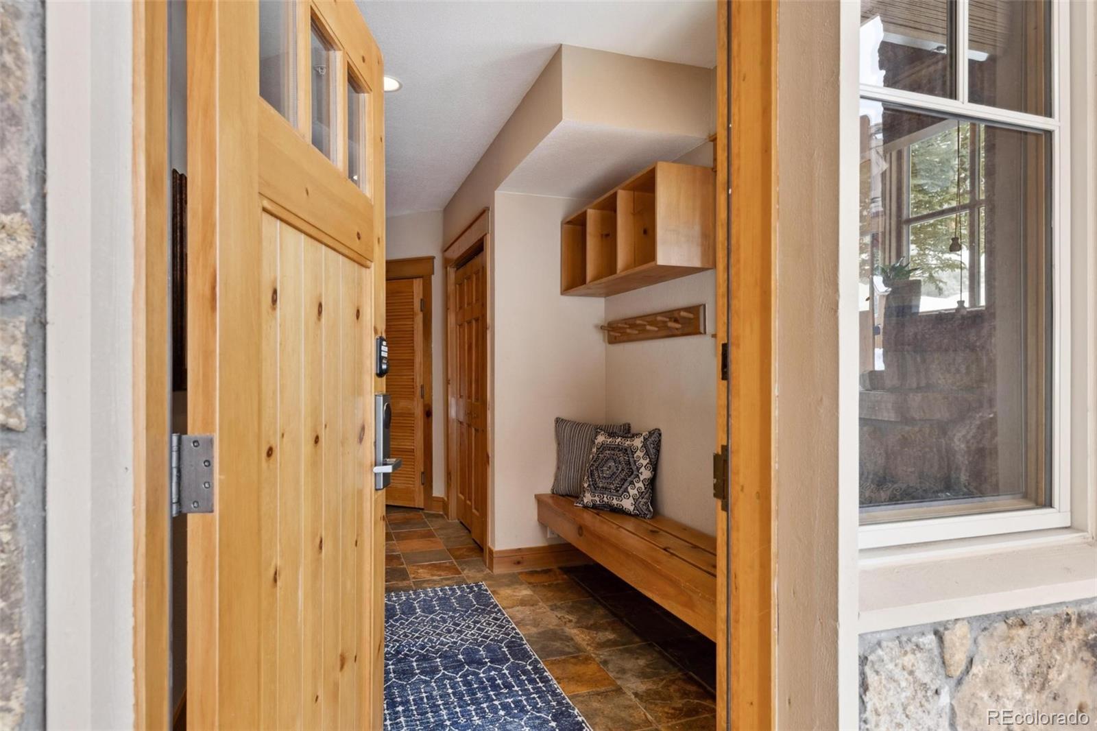 129 Tip Top Trail, Unit 6543 Dillon, CO 80435 - Photo 4 of 40 a view of a hallway with a livingroom and a dinning room with windows