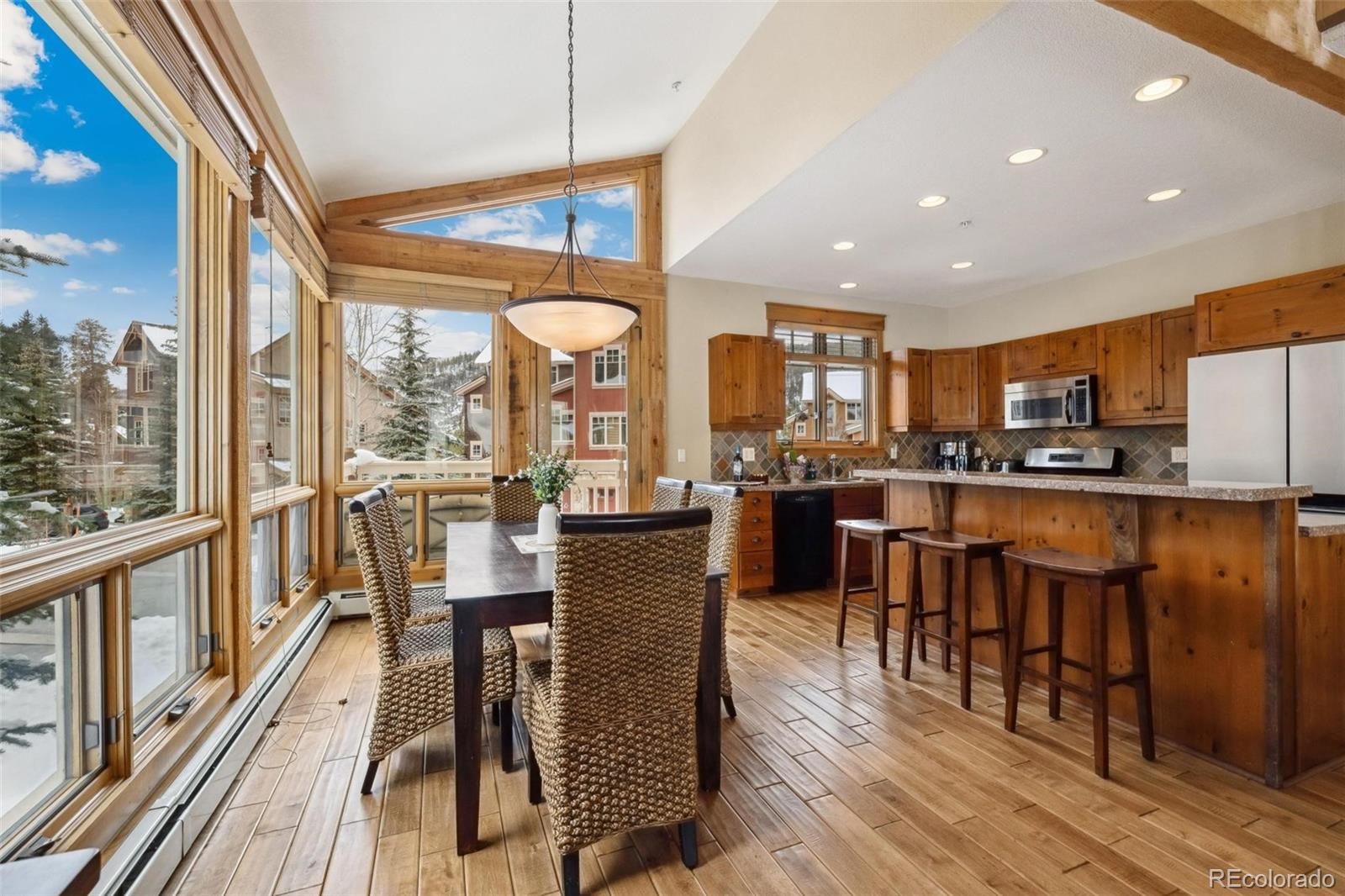 129 Tip Top Trail, Unit 6543 Dillon, CO 80435 - Photo 7 of 40 a view of a dining room with furniture window and wooden floor