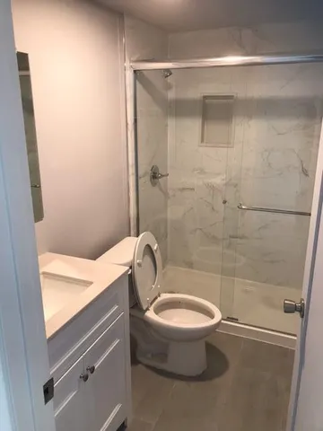 a bathroom with a toilet and a shower