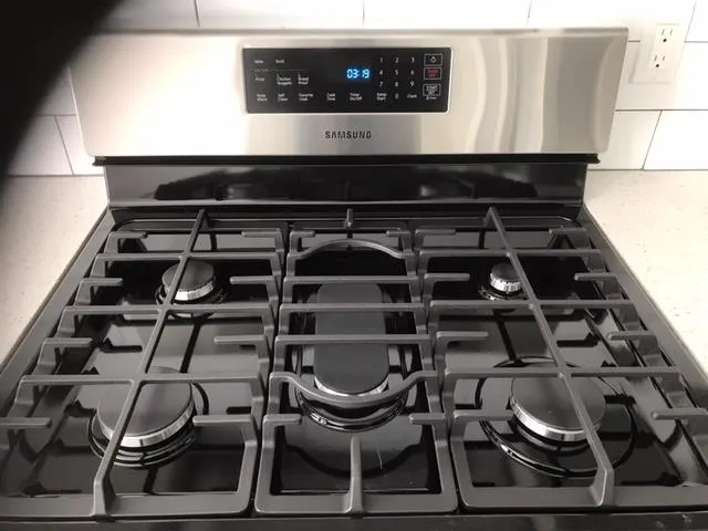 a stove top oven sitting inside of a kitchen