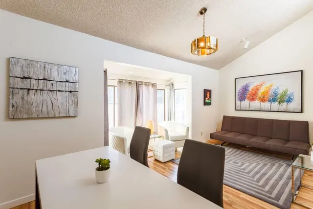 a living room with furniture and a chandelier