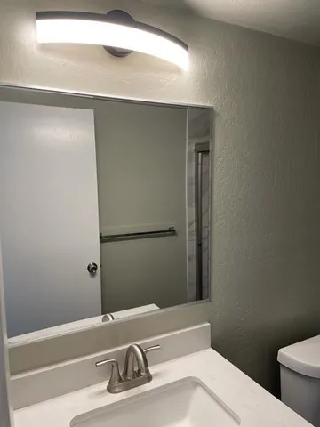 a bathroom with a sink and toilet