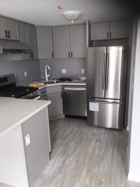 28 Houston Street San Francisco, CA 94133 - Photo 6 of 32 a kitchen with a refrigerator sink and cabinets