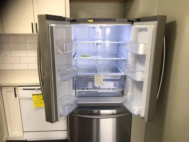 a room with water heater and a refrigerator