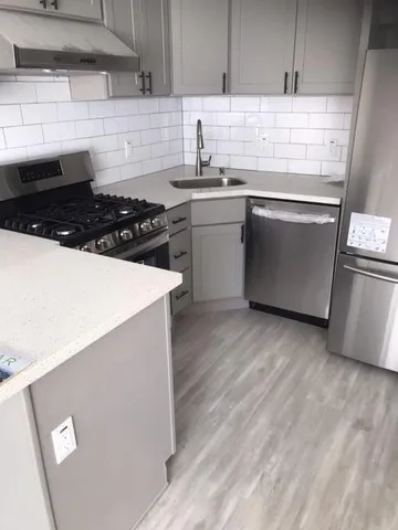 a kitchen with sink a stove and refrigerator