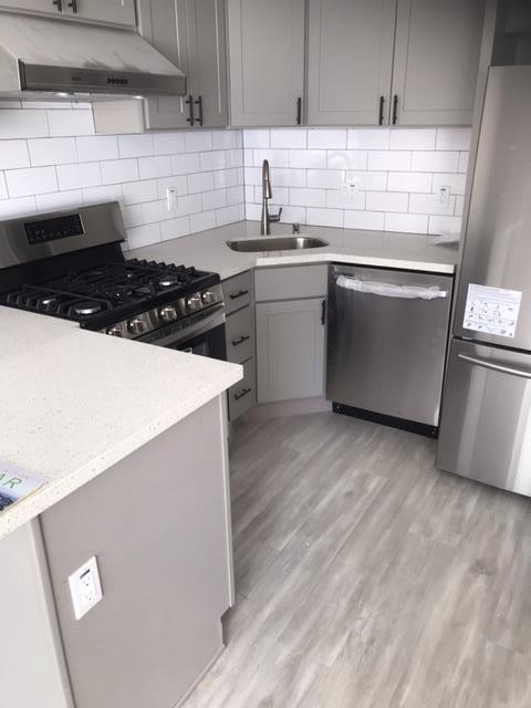 28 Houston Street San Francisco, CA 94133 - Photo 10 of 32 a kitchen with sink a stove and refrigerator