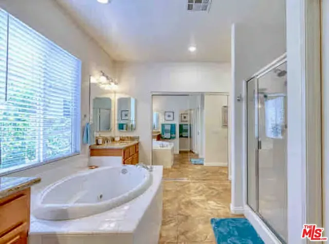a bathroom with a tub and shower