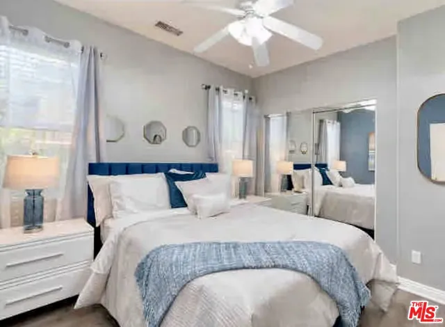 a bedroom with a large bed and a chandelier