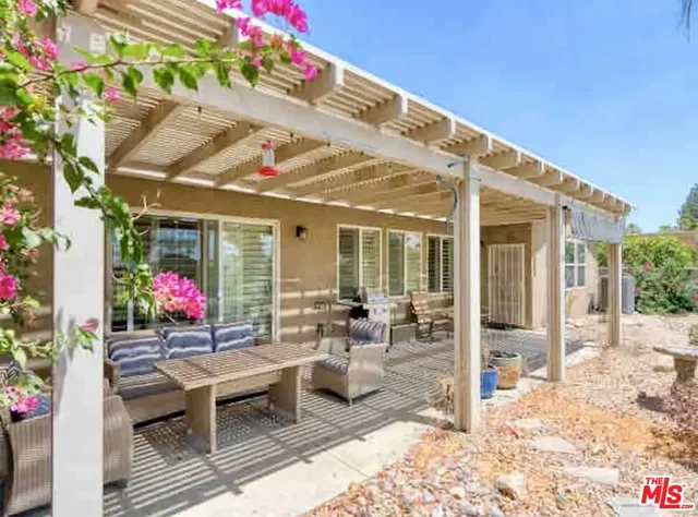 a view of a tables and chairs in patio of a house