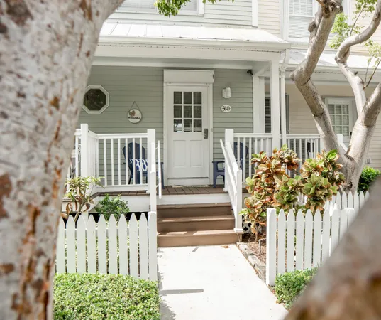 a front view of a house with a small yard