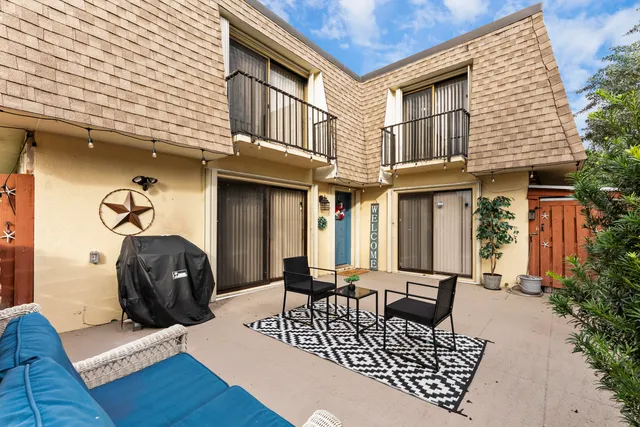 a view of a patio with a table and chairs