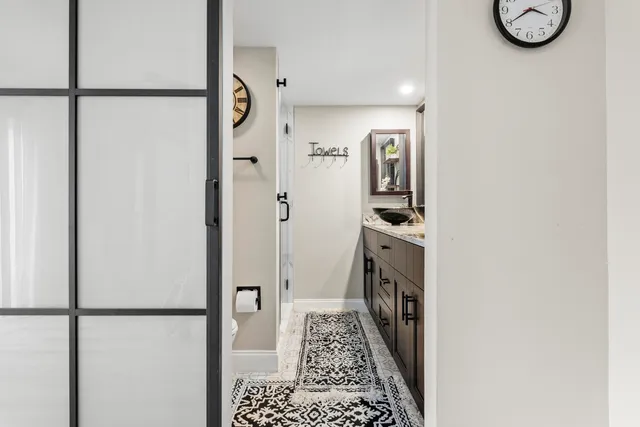 a walk in closet with wooden floor