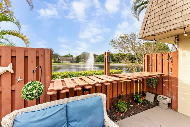 a view of a patio with couches and potted plants