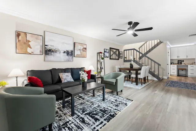 a living room with furniture and wooden floor