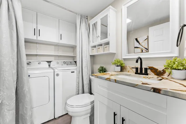 a view of bathroom with a sink toilet and shower
