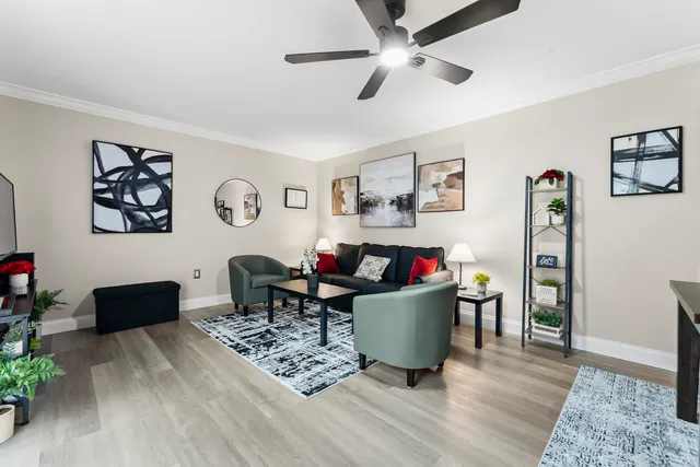 a living room with furniture and wooden floor