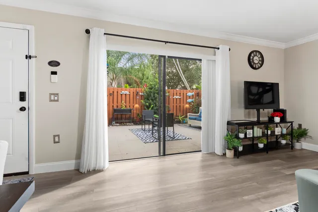 a view of a livingroom with wooden floor and a flat screen tv