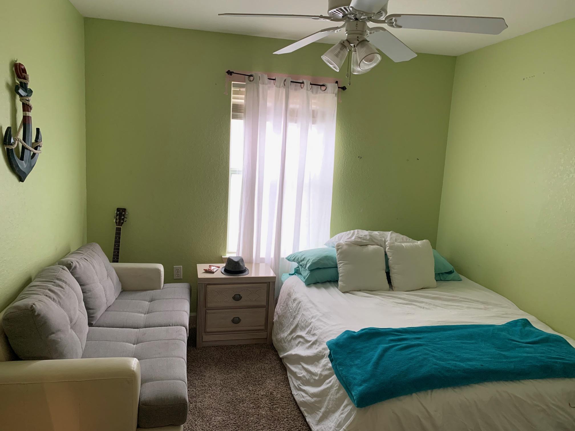 1014 Airport Road, Unit 114 Destin, FL 32541 - Photo 11 of 15 a bedroom with a bed couch and window