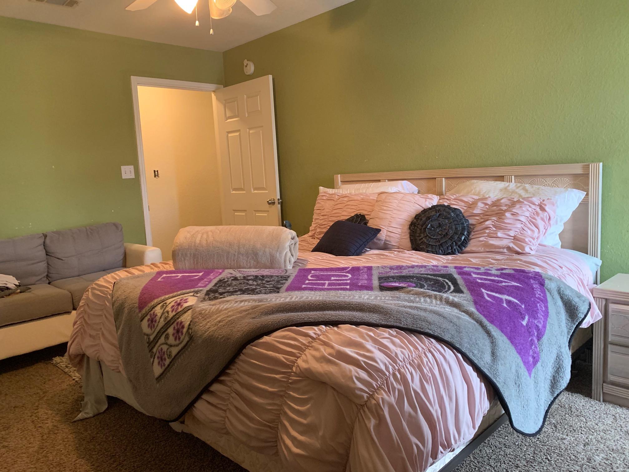 1014 Airport Road, Unit 114 Destin, FL 32541 - Photo 8 of 15 a bedroom with a bed and a couch